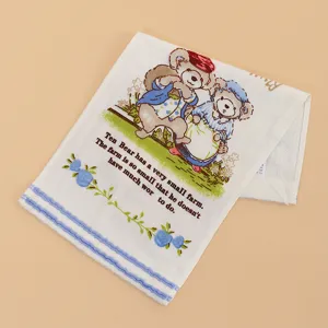Detailed view of soft cotton baby handkerchief featuring cute bear print and text.