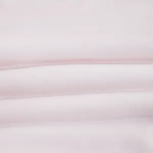 Soft pink fabric detail of baby swaddle blanket, breathable texture for cozy sleep.