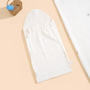 Close-up detail of soft white cotton gauze baby sleeping bag with cute hood for summer.