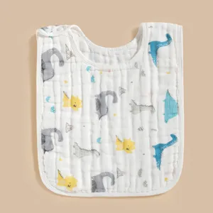 Détail du bavoir pour bébé en coton doux avec un joli imprimé dinosaure et bouton pression.