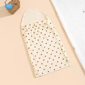 Cotton gauze baby sleeping bag detail showing cute brown heart pattern and comfortable hooded design.