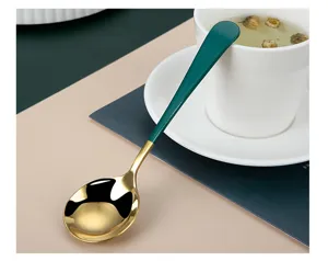 Stainless steel round spoon detail view, golden bowl with dark green handle, exquisite dessert spoon.