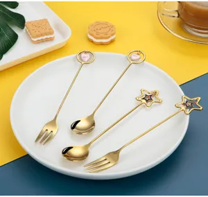 Stainless steel gold spoons and forks with cute heart and star charms for dessert and coffee.