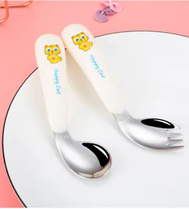 Stainless steel baby fork and spoon set detail, ergonomic toddler cutlery tableware.