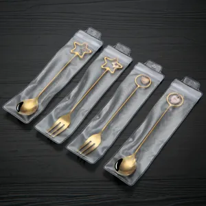 Gold stainless steel creative spoon fork set with heart and star charm for dessert and coffee.