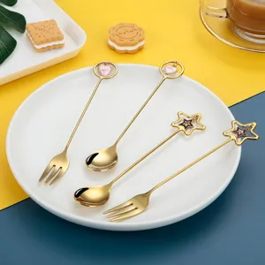 Creative stainless steel gold spoon and fork set with cute heart and star charms for home.