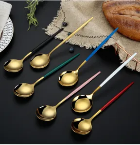 Stainless steel long handle round spoon with gold finish and colorful handles for table decor.