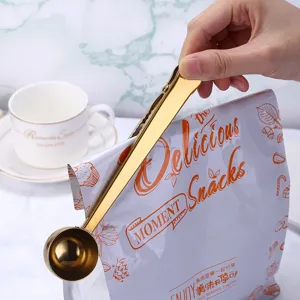 Stainless steel coffee measuring spoon with sealing clip, golden multifunctional kitchen baking tool.