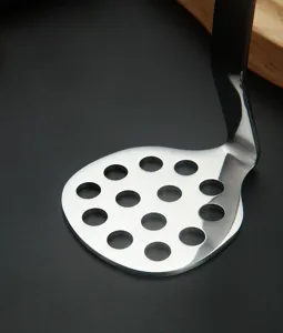Stainless steel potato masher detail shot, featuring durable perforated pressing plate.
