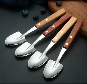 Stainless steel shovel spoons with wooden handles, detailed close-up of creative dessert spoons.