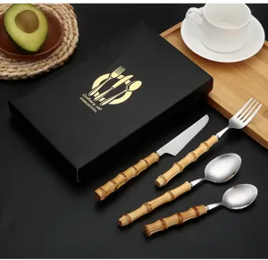 Stainless steel cutlery set with natural bamboo handle, knife, fork and spoon.