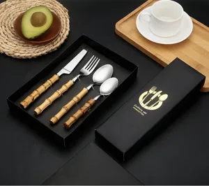 Stainless steel cutlery set with natural bamboo handles, elegant dinnerware for kitchen and dining.