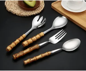 Stainless steel tableware set with natural bamboo handle, detailed shot of cutlery set.