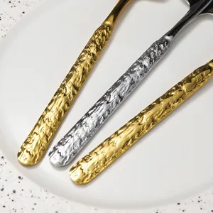 Stainless steel dessert spoons with hammered handles, elegant tableware for fruit and cakes.