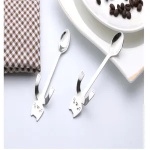 Detail view of cute cat stainless steel hanging spoons, perfect for coffee stirring and mugs.