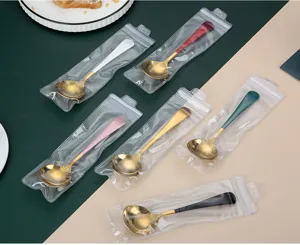 Stainless steel round spoons with colorful handles, individually packaged in clear ziplock bags.