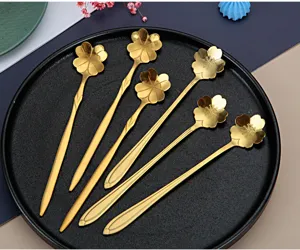 Detail view of the elegant stainless steel gold cherry blossom spoon, perfect for coffee and desserts.