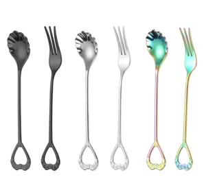 Stainless steel shell spoon fork detail, creative heart handle tableware close up view.