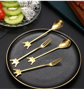 Detailed view of gold crown stainless steel spoon and fork set for dessert and coffee.