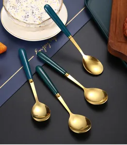 Stainless steel ceramic spoon detail, dark green gold handle tableware close-up display