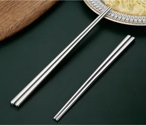 Stainless steel chopsticks detail shot, polished metal surface, durable kitchenware item display.