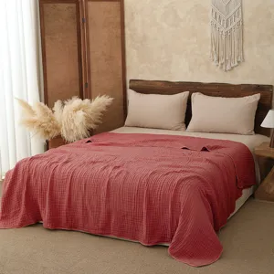 Cozy gauze blanket in bedroom scene, soft cotton texture, ideal for summer cool bedding detail.