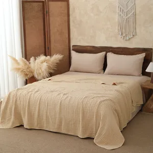 Detail view of pure cotton gauze summer blanket, soft solid color bed throw and quilt.