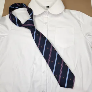 Detailed view of dark blue school uniform tie with pink stripes and delicate crown embroidery.