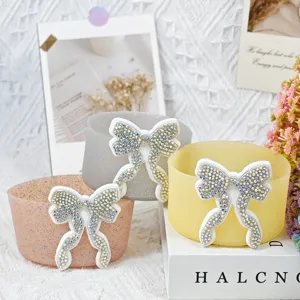 Silicone cup sleeve with sparkling rhinestone bow, perfect accessory and protector for Stanley cups.