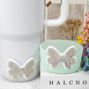 Silicone cup sleeve and coaster with sparkly rhinestone bow detail for tumbler accessories.