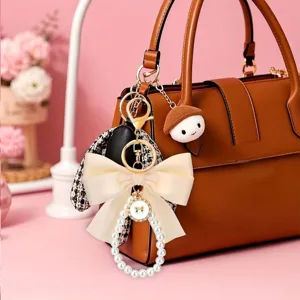 Schattige tweed strik parel tas hanger sleutelhanger, elegante gouden metalen accessoire.