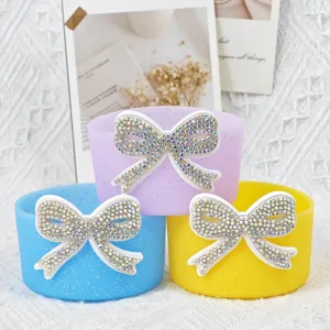 Colorful silicone cup boot detail with sparkling rhinestone bow decoration for 7.5cm cups.