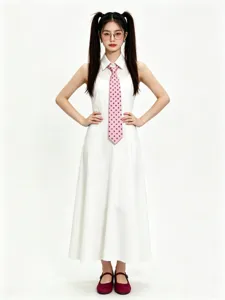 Detail shot of a white dress paired with a pink polka dot tie, elegant and vintage style.