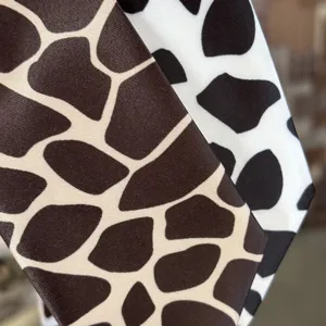 Detailed close-up of kids tie featuring cute animal print fabric, smooth texture.