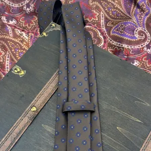 Brown jacquard woven silk tie for men featuring stylish blue floral pattern formal wear.