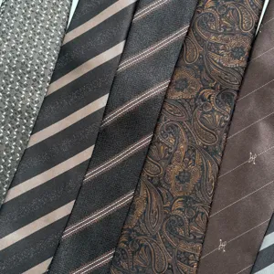 Retro brown silk tie detail showing various classic striped and paisley patterns clearly.