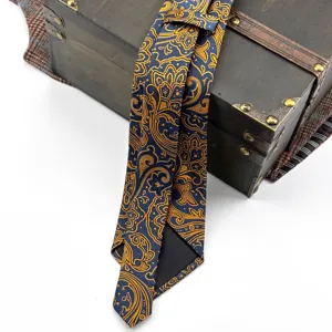 Detailed view of luxury blue and gold paisley silk tie, retro palace style men's necktie.