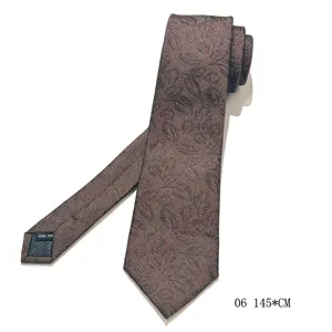 Brown leaf pattern tie detail showcasing premium fabric texture and neat handmade tailoring.