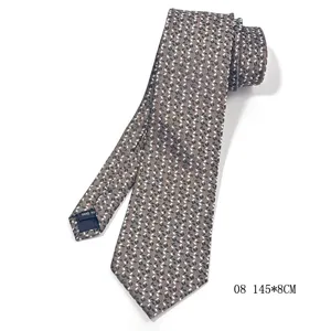 Detail view of brown handmade silk necktie with intricate dot pattern, measuring 145x8cm.