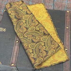 Detail of yellow and black paisley jacquard fabric, elegant retro pocket square texture.