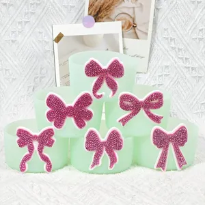 Detailed shot of green silicone cup sleeve with pink crystal bow decoration, perfect accessory.