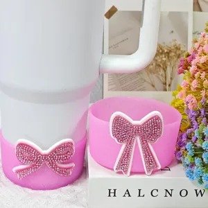 Close-up detail of pink silicone cup boot and coaster with sparkling rhinestone bow detail.