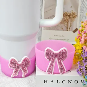 Silicone tumbler boot and coaster set with sparkling rhinestone bow for Stanley cups.