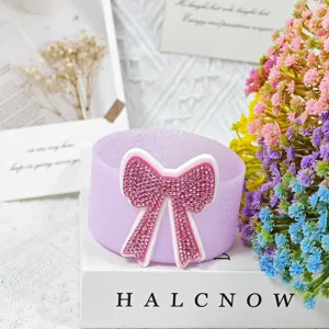 Silicone cup sleeve for Stanley tumbler with pink rhinestone bow accessory detail view.