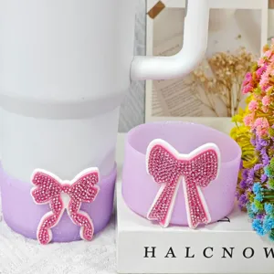 Silicone tumbler boot and coaster set with rhinestone bow detail for Stanley accessories.