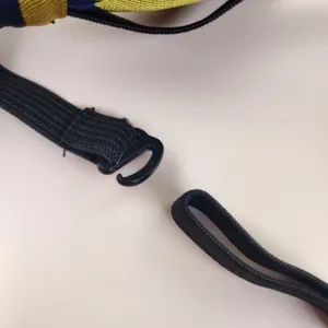 Detail shot of the adjustable elastic strap and plastic hook for school uniform tie accessory.