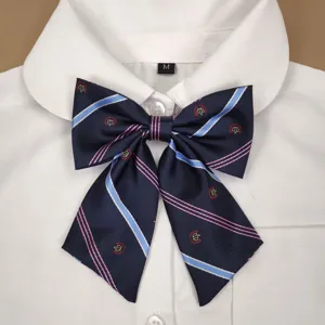 Detailed view of JK uniform bow tie with navy blue striped design and crown embroidery.