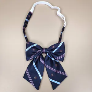JK uniform bow tie with navy blue, pink and light blue stripes, crown print, adjustable strap.