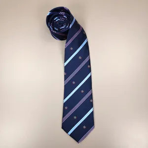 Navy blue JK uniform necktie with diagonal stripes and crown pattern detail close-up.
