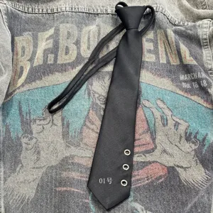 Punk style black necktie with metal eyelets and unique design for men and women fashion wear.